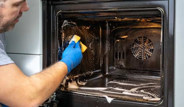 What cleaning products are safe to use on my Kitchen Aid oven